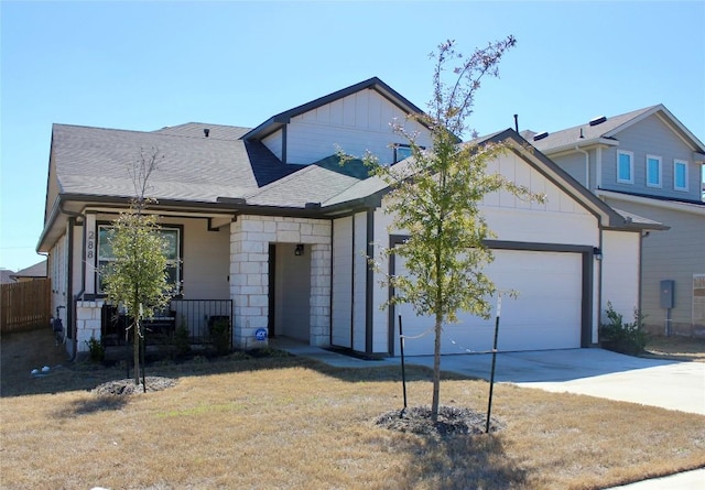 view of front of property with a garage, a front lawn, board and batten siding, and concrete driveway