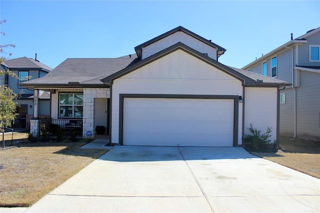 view of front of home with an attached garage, driveway, a front lawn, and board and batten siding