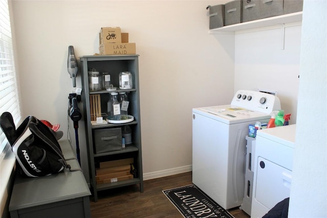 laundry area with washer and dryer, laundry area, baseboards, and wood finished floors