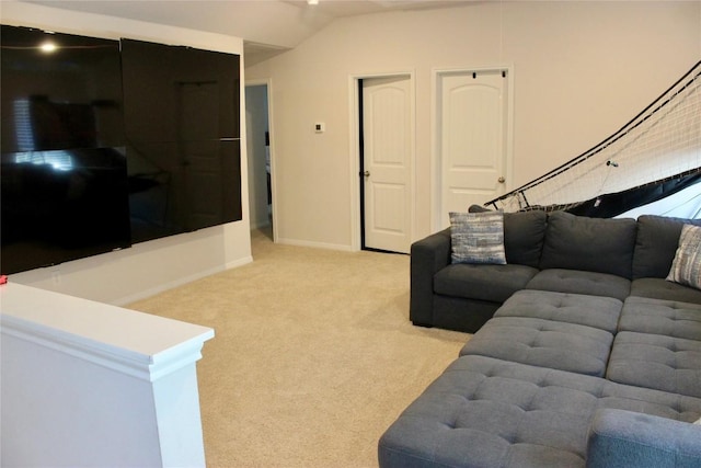 living room with baseboards, lofted ceiling, and light colored carpet