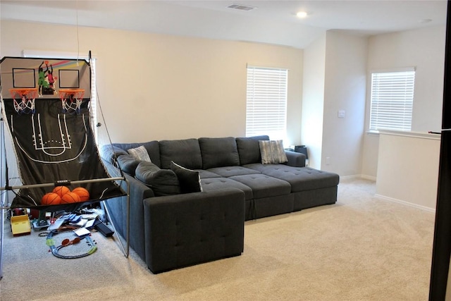 living area featuring carpet floors, visible vents, and baseboards