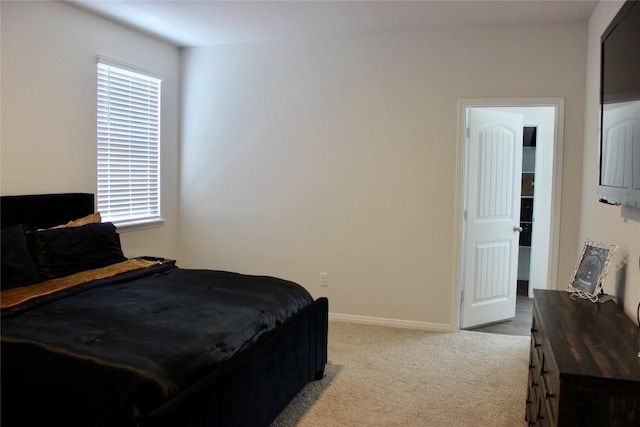 bedroom with carpet floors, multiple windows, and baseboards