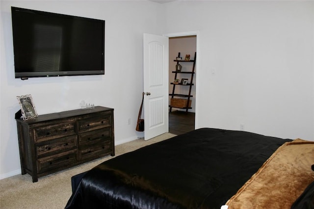 carpeted bedroom featuring baseboards