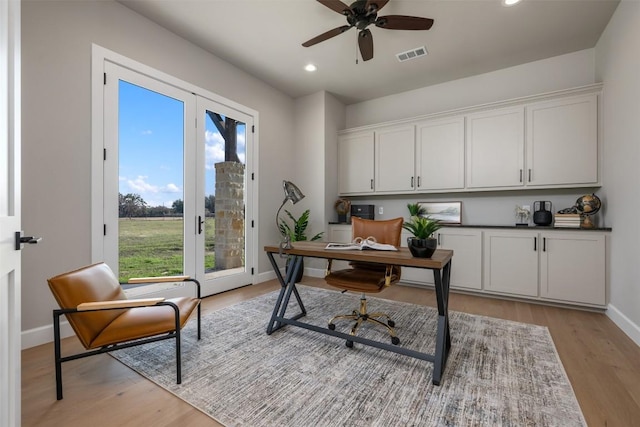 home office featuring light wood-type flooring, visible vents, baseboards, and recessed lighting