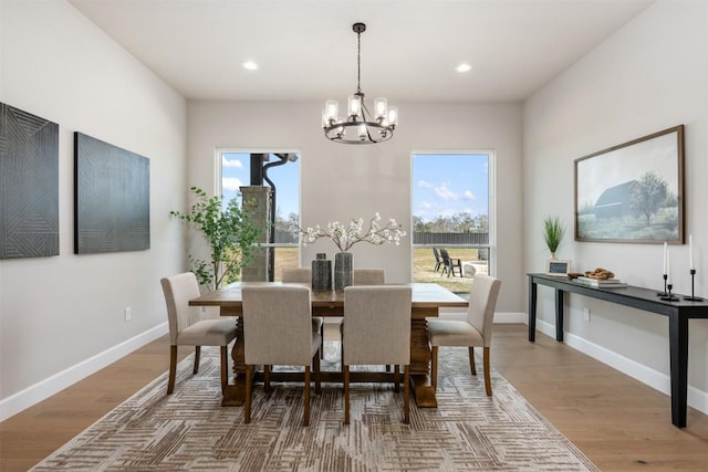 dining area featuring a chandelier, recessed lighting, wood finished floors, and baseboards