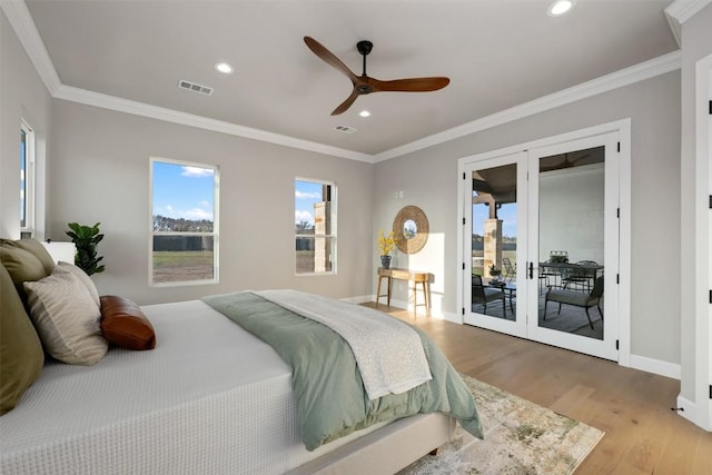 bedroom featuring visible vents, light wood-style floors, access to outside, ornamental molding, and french doors