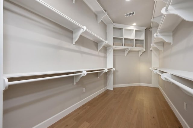 walk in closet with visible vents and wood finished floors