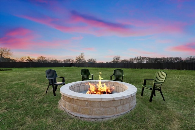 yard at dusk with a fire pit