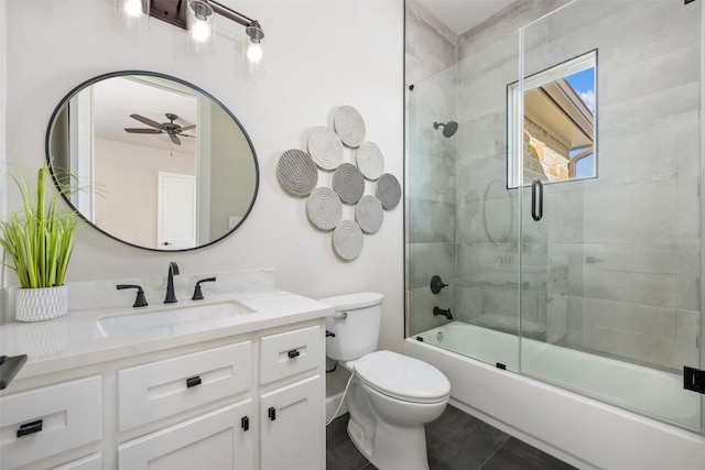 full bath with shower / bath combination with glass door, vanity, toilet, and ceiling fan