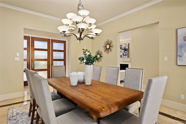 dining space featuring a fireplace, light tile patterned floors, an inviting chandelier, ornamental molding, and baseboards