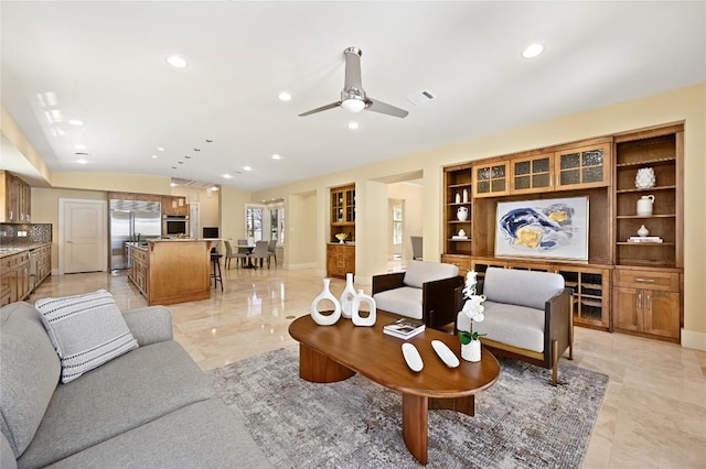 living area with lofted ceiling, baseboards, built in features, and recessed lighting