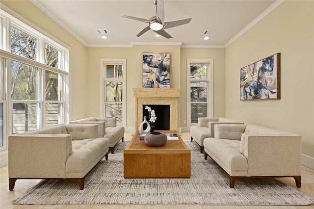 living area featuring ornamental molding, a fireplace, visible vents, and recessed lighting