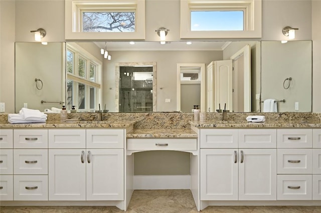 full bath featuring a shower stall, two vanities, and tile patterned floors