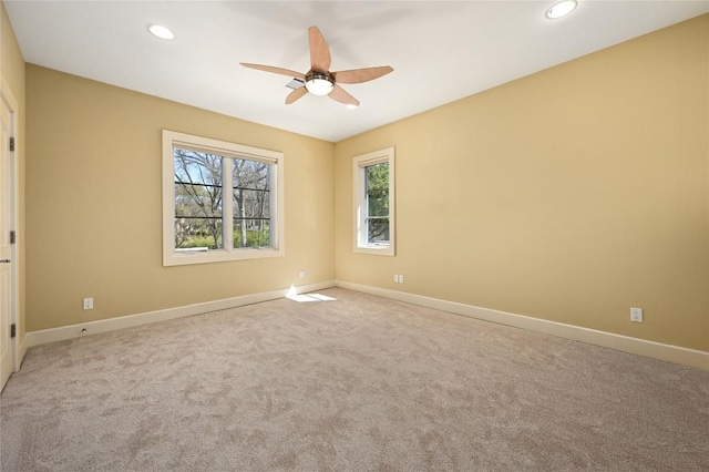 carpeted spare room featuring a ceiling fan, recessed lighting, and baseboards