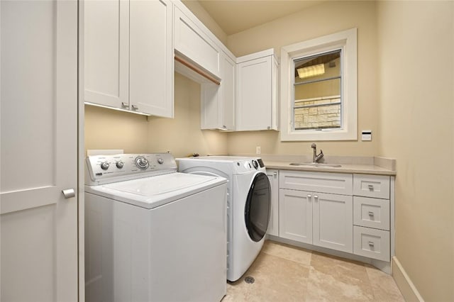 laundry room with washer and dryer, cabinet space, a sink, and baseboards