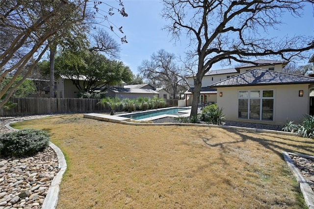 view of yard featuring a patio area, a fenced backyard, and a fenced in pool