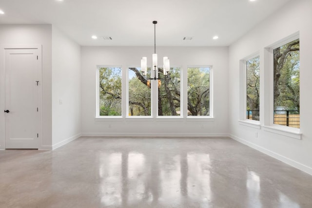 unfurnished dining area featuring concrete floors, baseboards, a notable chandelier, and recessed lighting