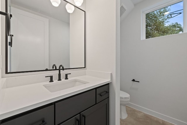 bathroom with visible vents, baseboards, vanity, and toilet