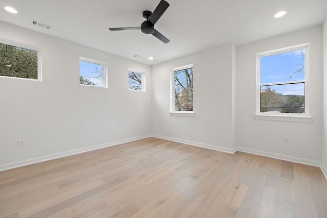 spare room featuring baseboards, visible vents, a ceiling fan, light wood-style floors, and recessed lighting