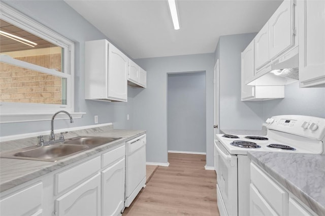 kitchen featuring white appliances, light countertops, under cabinet range hood, white cabinetry, and a sink