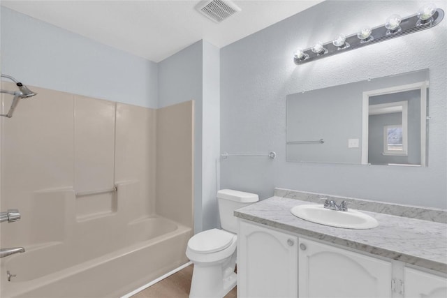 bathroom featuring toilet,  shower combination, vanity, and visible vents