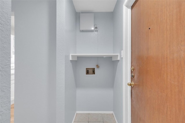 washroom featuring laundry area, baseboards, washer hookup, and tile patterned floors