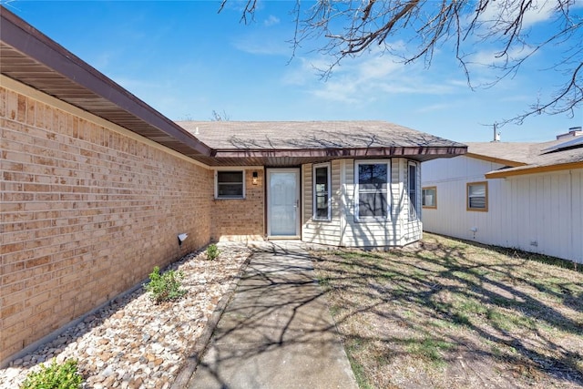 doorway to property with brick siding