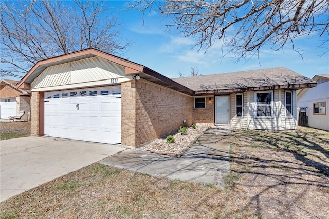 single story home featuring driveway, brick siding, and an attached garage