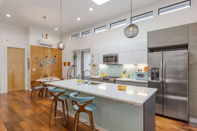 kitchen featuring a sink, white cabinetry, appliances with stainless steel finishes, backsplash, and modern cabinets