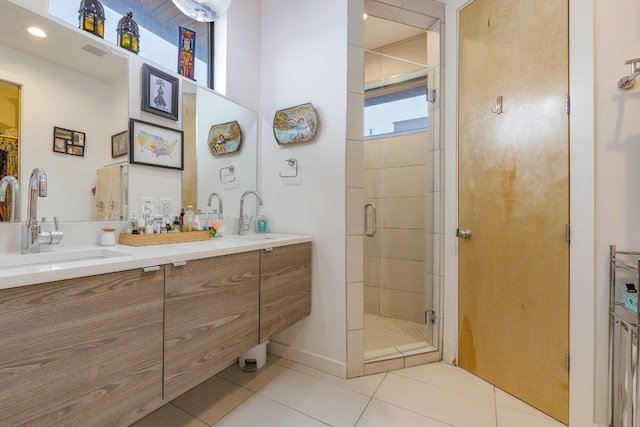 bathroom featuring a stall shower, vanity, visible vents, and tile patterned floors