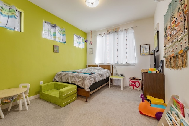 bedroom featuring carpet flooring and baseboards