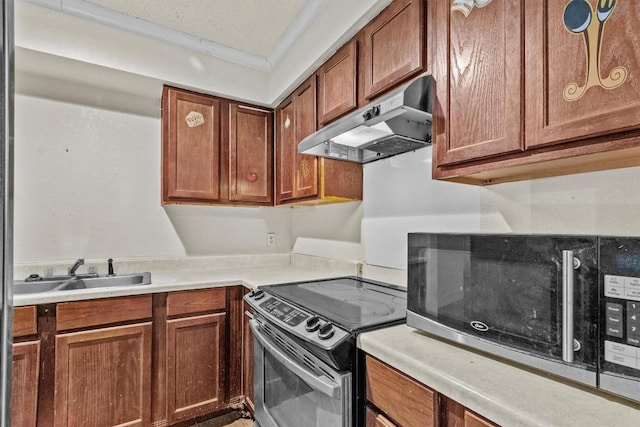 kitchen featuring range with electric stovetop, light countertops, stainless steel microwave, a sink, and under cabinet range hood