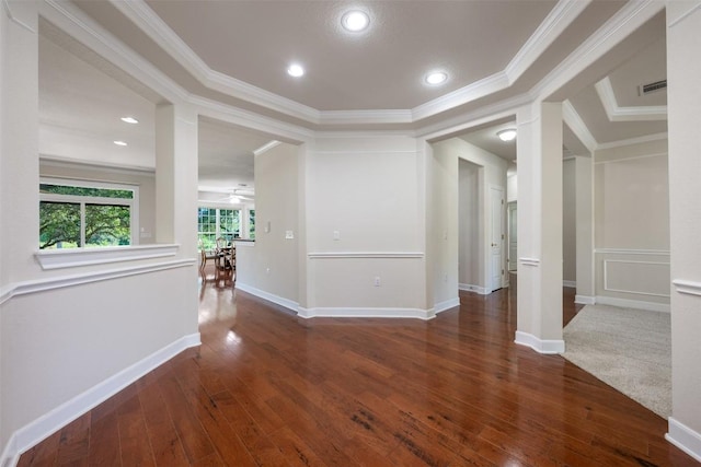 empty room with wood-type flooring, baseboards, and crown molding