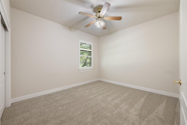 unfurnished bedroom with carpet, baseboards, ceiling fan, and a closet