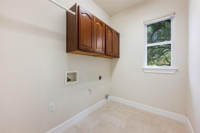 laundry area featuring hookup for a washing machine, hookup for an electric dryer, hookup for a gas dryer, baseboards, and cabinet space