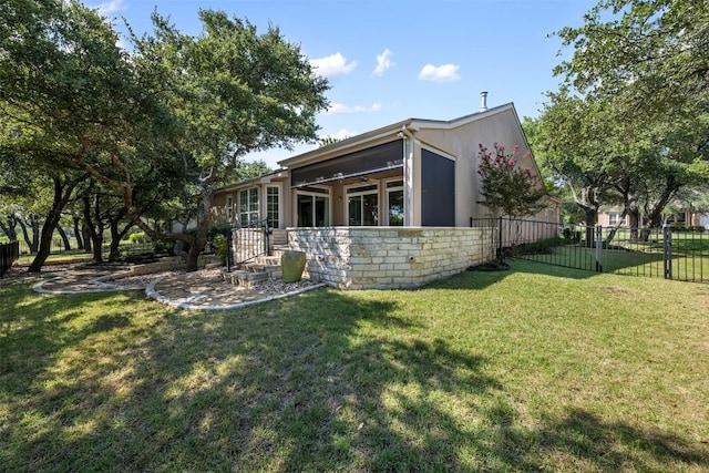 view of side of home featuring stone siding, a lawn, fence, and stucco siding