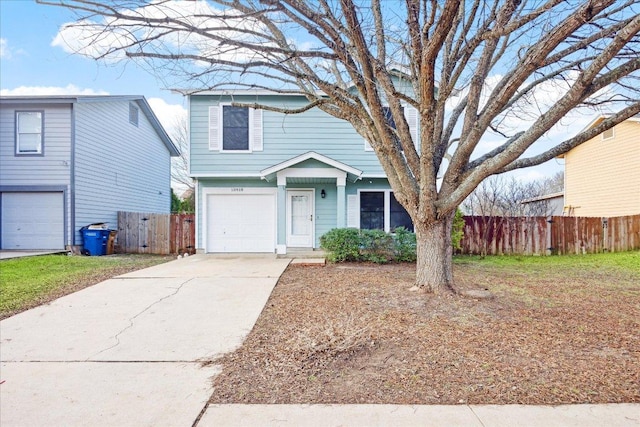 view of front of house with concrete driveway, an attached garage, and fence