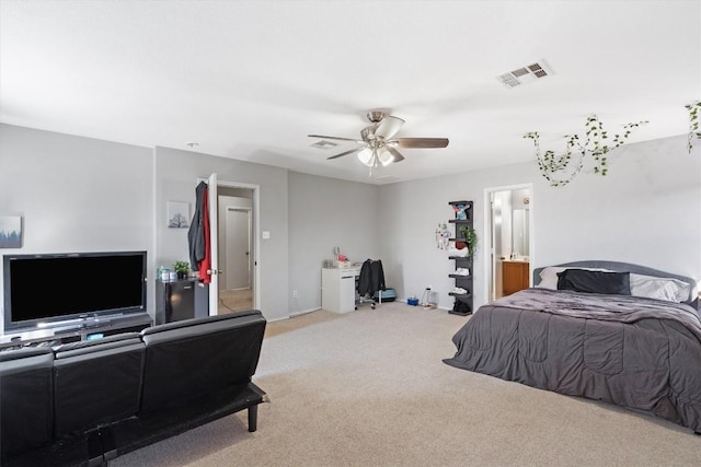 carpeted bedroom featuring connected bathroom, visible vents, and ceiling fan