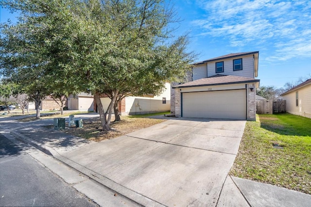 view of front of home with driveway, brick siding, a front yard, and fence