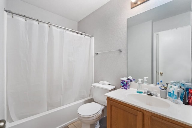 bathroom featuring toilet, a textured wall, shower / bath combo, and vanity