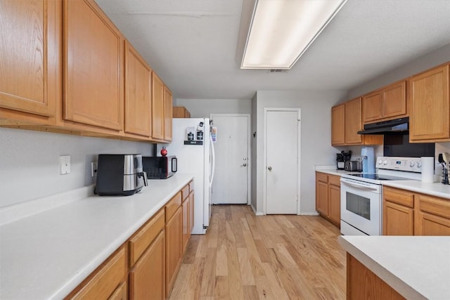 2112 Perkins Pl, Georgetown, TX 78626 - kitchen with white appliances, under cabinet range hood, light wood-style flooring, and light countertops