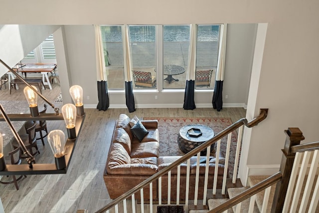 living area with baseboards and wood finished floors