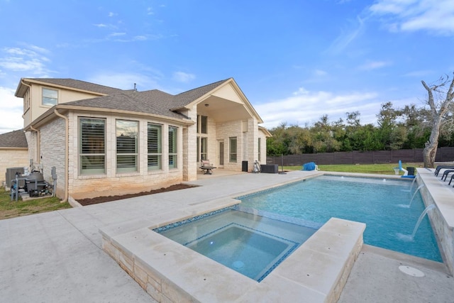 view of pool featuring a patio area, a fenced backyard, and a pool with connected hot tub