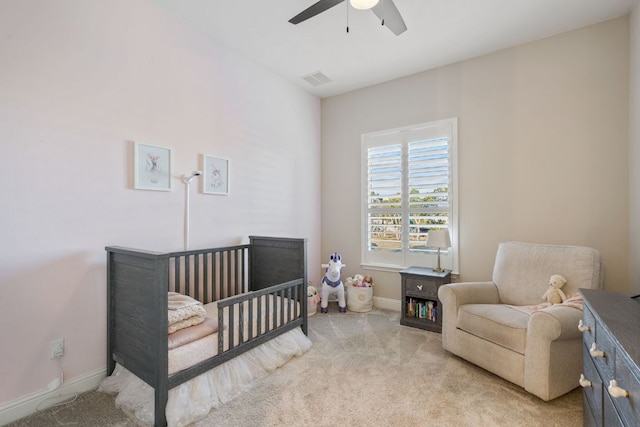 bedroom featuring a ceiling fan, light carpet, visible vents, and baseboards