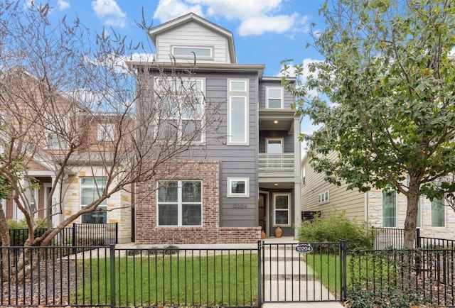 multi unit property with a front lawn, a fenced front yard, and brick siding