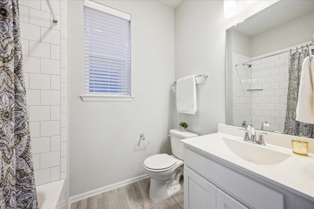 10204 Jacksboro Trl, Austin, TX 78717 - bathroom featuring vanity, wood finished floors, toilet, shower / bath combo with shower curtain, and baseboards