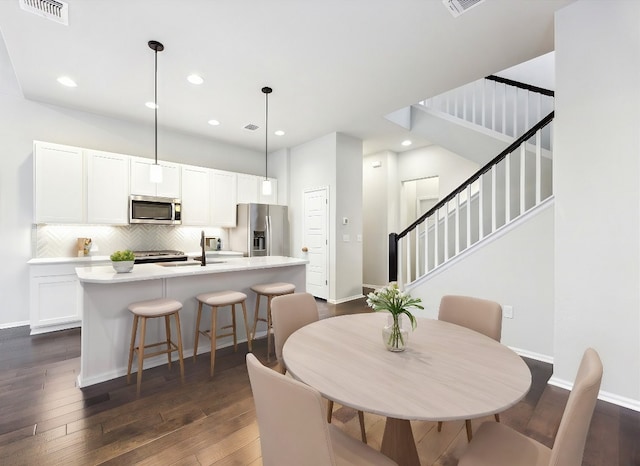 10204 Jacksboro Trl, Austin, TX 78717 - dining space with stairs, dark wood-type flooring, baseboards, and recessed lighting