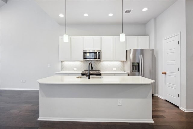 10204 Jacksboro Trl, Austin, TX 78717 - kitchen featuring stainless steel appliances, dark wood finished floors, decorative backsplash, a sink, and white cabinets