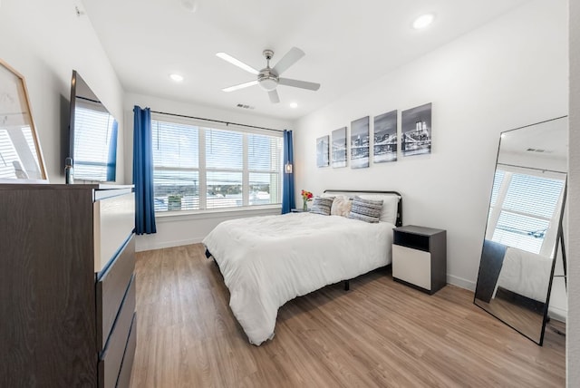 bedroom featuring light wood finished floors, baseboards, and recessed lighting