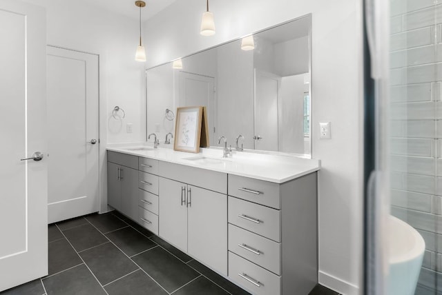 bathroom with tile patterned flooring, a sink, and double vanity